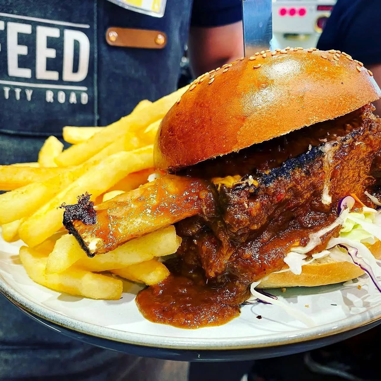 Handcrafted burger and chips on the counter at Feed Jetty Road