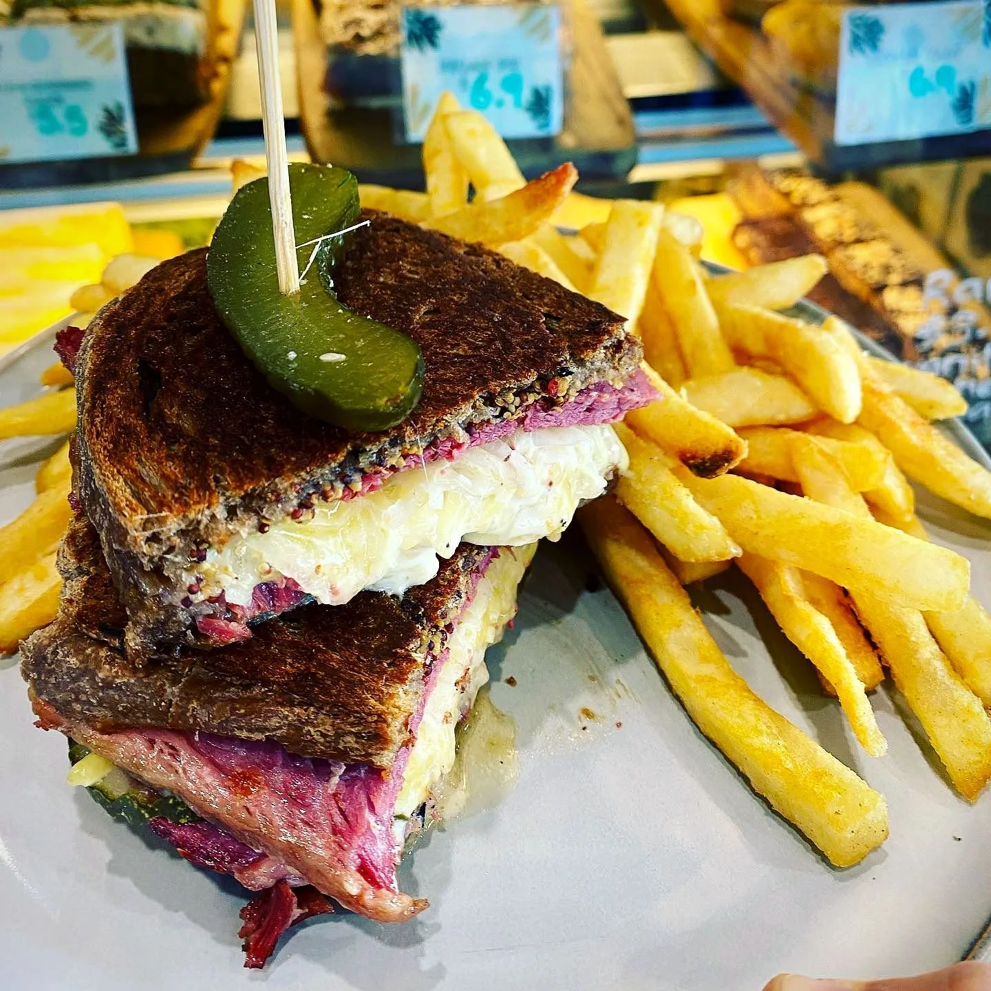 Stacked toastie with a pickle and a pile of chips
